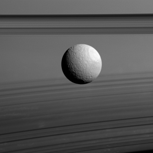 carolynporco:Another week at Saturn has gone by. Here, Tethys with rings and shadows… CICLOPS.org: I