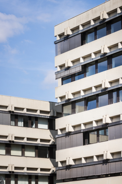 Classic brutalist administration building in Trier with cantilevered beams and repainted exposed con