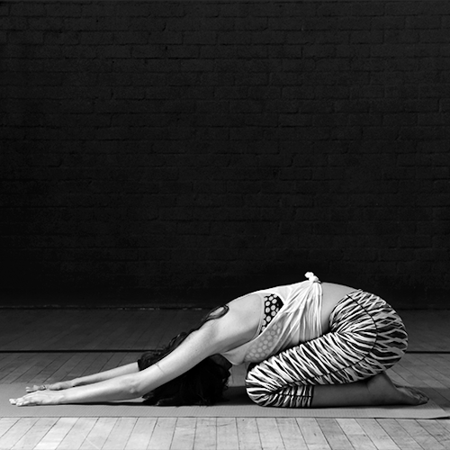 GIF of a woman in Child's pose.