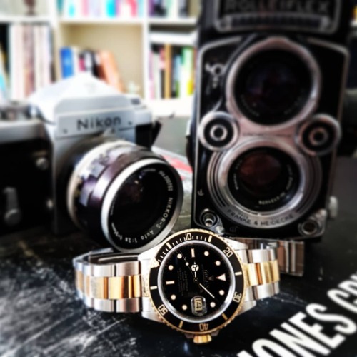 Rolex sub 16803, gold and steel watch. Together with my old cameras, nikon F and rolliflex. My summe