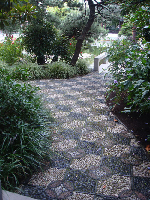 asylum-art:  10 Magical Pebble Paths That Flow Like Rivers   The garden or back-yard is one of the best places in a home for the home-owner to express their creative side. Why surround all those beautiful plants with an ugly path when you can create a