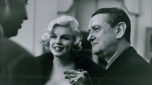 Georges Auric drinking champagne at a party with Marilyn Monroe.
