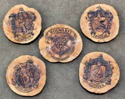 wickedclothes:  Hogwarts House Crest Drink Coasters Drink coasters for all Harry Potter fans. Featuring a coaster with each house crest as well as the Hogwarts crest. Sold on Etsy.