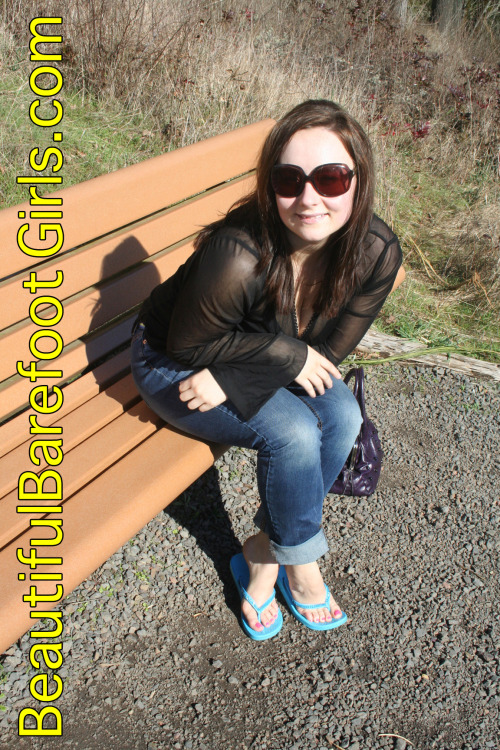 beautifulbarefootgirls:Here is the super cute Amy, sitting on the public park bench with her feet on the ground wearing a pair of blue flip-flops. She is smiling because she can’t wait to get her toes out of those sandals and show off cute super cute