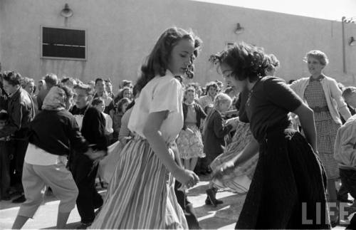 Dance contest holds a preliminary rounds in a parking lot(Loomis Dean. 1955?)