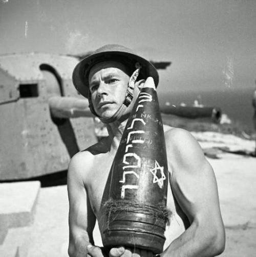 eretzyisrael:  This  image is of a man in the Jewish Brigade, a formation of the British  Army that fought the Germans in Italy in 1944. The rocket says “A gift  for Hitler"The Israel Project