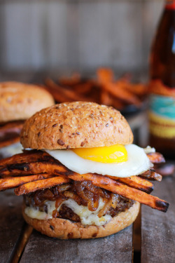 yummyinmytumbly:   Epic Crispy Quinoa Burgers Topped with Sweet Potato Fries, Beer Caramelized Onions + Gruyere 