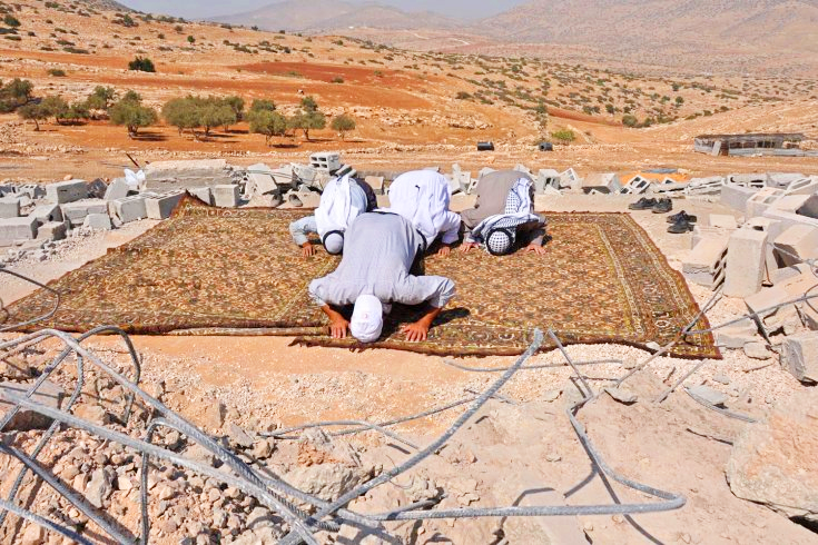 islamic-art-and-quotes:  Praying on mosque ruins bulldozed by Israel in the West