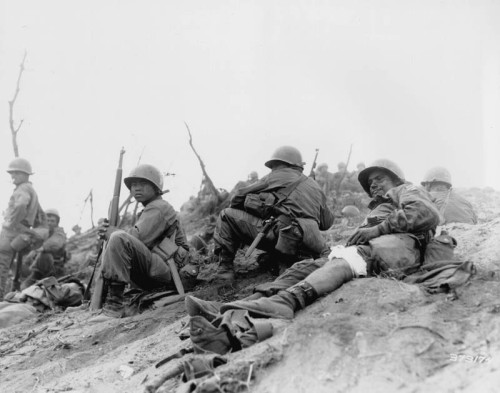 Cpl. Sam Ayala of Niles, Calif., Co. L, 7th RCT, U.S.3rd Infantry Division, waits for medical evacuation from Hill 717, Cpl. Ayala was wounded while engaged in a bitter grenade battle with deeply entrenched Chinese Communism/3 July 1951.