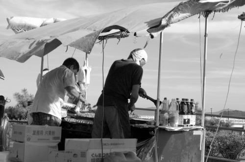 Men making yakisoba (fried noodles) at the beach, Gamagori, Japan