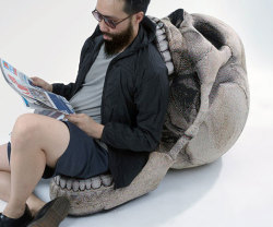 awesomeshityoucanbuy:  Skull ChairGive your room a macabre ambiance with the skull chair. Designed to look like a human skull, the chair features a realistic wrap-around graphic and comes with a movable jaw piece that lifts up to reveal a comfy and cozy