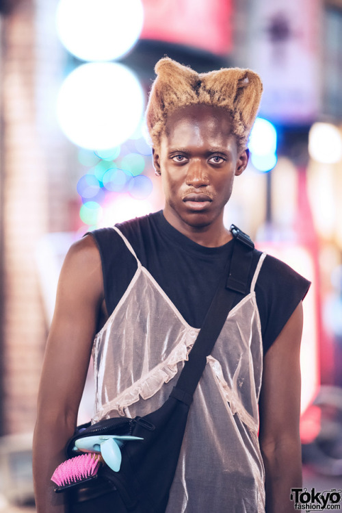 Zelig Wilson on the street in Harajuku at night. His look - including items from J.W. Anderson, H&am