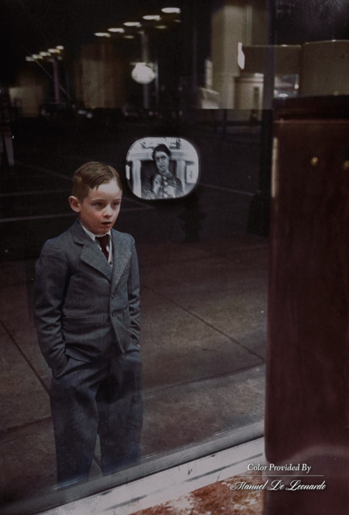 Boy watching TV for the first time in an appliance store window, 1948.