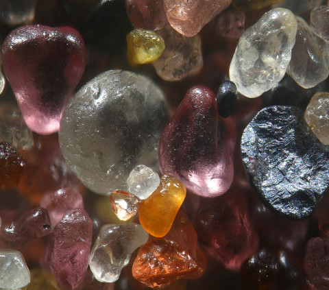 odditiesoflife:  Tiny Grains of Sand Magnified 100-300 Times Who knew sand could look so incredibly colorful and unique? Gary Greenberg, that’s who, whose incredible macro photography techniques reveal each grain of sand to be a kaleidoscope of color