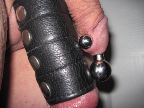 A 00 gauge curved barbell and 4" leather ball stretcher together feel great as both my cock and balls are pulled downwards!