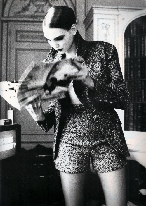 Nadja Auermann reads in “She is an Enigma” for UK Vogue, October 1991. Photograph by Ell