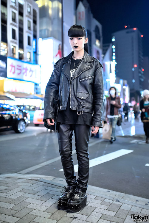 18-year-old Chikio on the street in Harajuku wearing a resale leather biker jacket over a Neon Genes