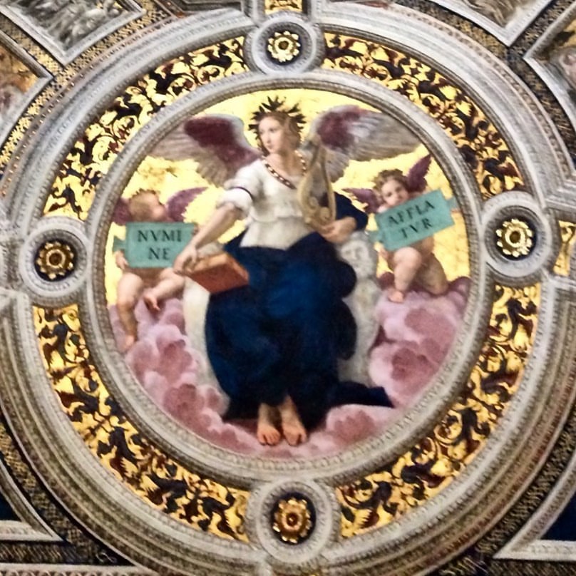 Città del Vaticano🚩Musei Vaticani, Stanze di Raffaello, Stanza della Segnatura. È il tondo, o clipeo con la Poesia che si trova sopra il Parnaso. Si tratta di una figura angelica alata, affiancata da due putti-angeli che reggono due tabelle biansate...