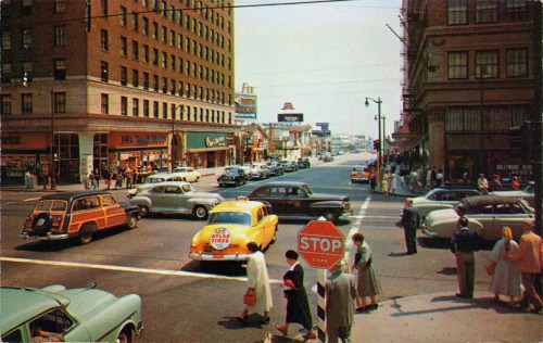 Color view of Hollywood and Vine, 1950’s. The distinctive shape of the Brown Derby sign can be seen in the center distance.