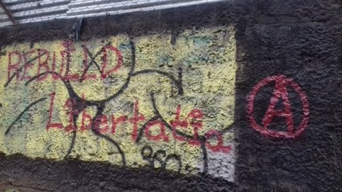 Solidarity graffiti for Libertatia, a squatted anarchist social centre in Thessaloniki, which was to