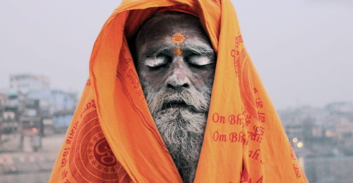 Buba Sadhu Taking a nap by the Ganges River In Varanasiphotography copyright by Katren Sudek