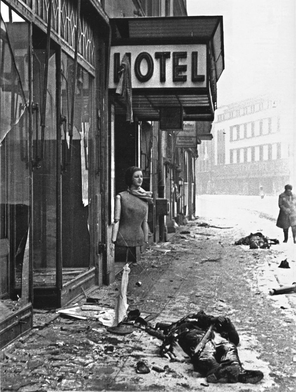  A happy figure watches over dead German soldiers in Berlin, March 1945 