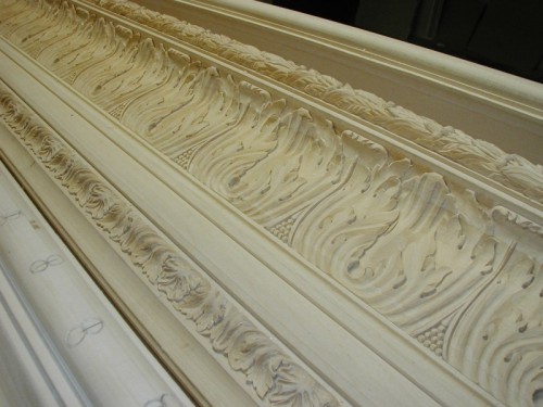 This reproduction of a 19th century frame was carved entirely by hand. The moulding is 12 inches wide and is finished in 22k gold leaf over yellow clay with red highlights. The pictures above show some of the steps during production.