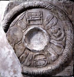 hellenismo:  Sculptured marble panel dedicated by women officials of a cult of Demeter. The dedications are inscribed on paterae, surrounded by items of women’s clothing and make-up, probably dedicated to the Goddess. The borders of corn and barley