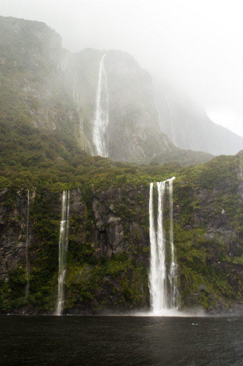 Waterfalls down the steep valley walls at Milford Sound.Milford Sound, Fiordland, South Island, New 