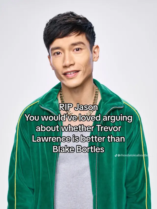 A picture of Jason Mendoza wearing a gray shirt and green jacket wearing a necklace. His arms are by his side and he is smiling. There is text over the image that reads "RlP Jason You would'veloved arguing about whether Trevor Lawrence is better than Blake Bortles"