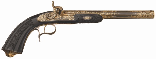 A pair of gold inlaid percussion dueling pistols with carved ebony stocks, crafted by Devisme of Par