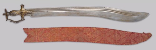 An Unusual Tulwar-Hilted Mughal Sword, 18th or Early 19th Century Broad, 28 inch recurved watered st