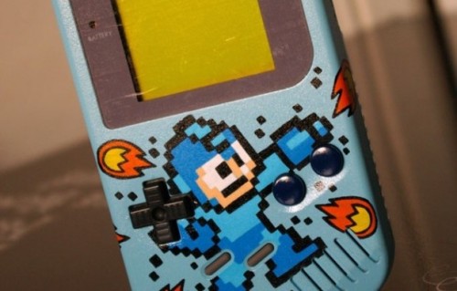 pxlbyte:  Custom Mega Man Game Boy This was created by Oskunk and unfortunately this is a one of a kind design, he has no plans on creating another. It should also be noted that he used the standard gray model as a base, so its truly a 100% custom design.