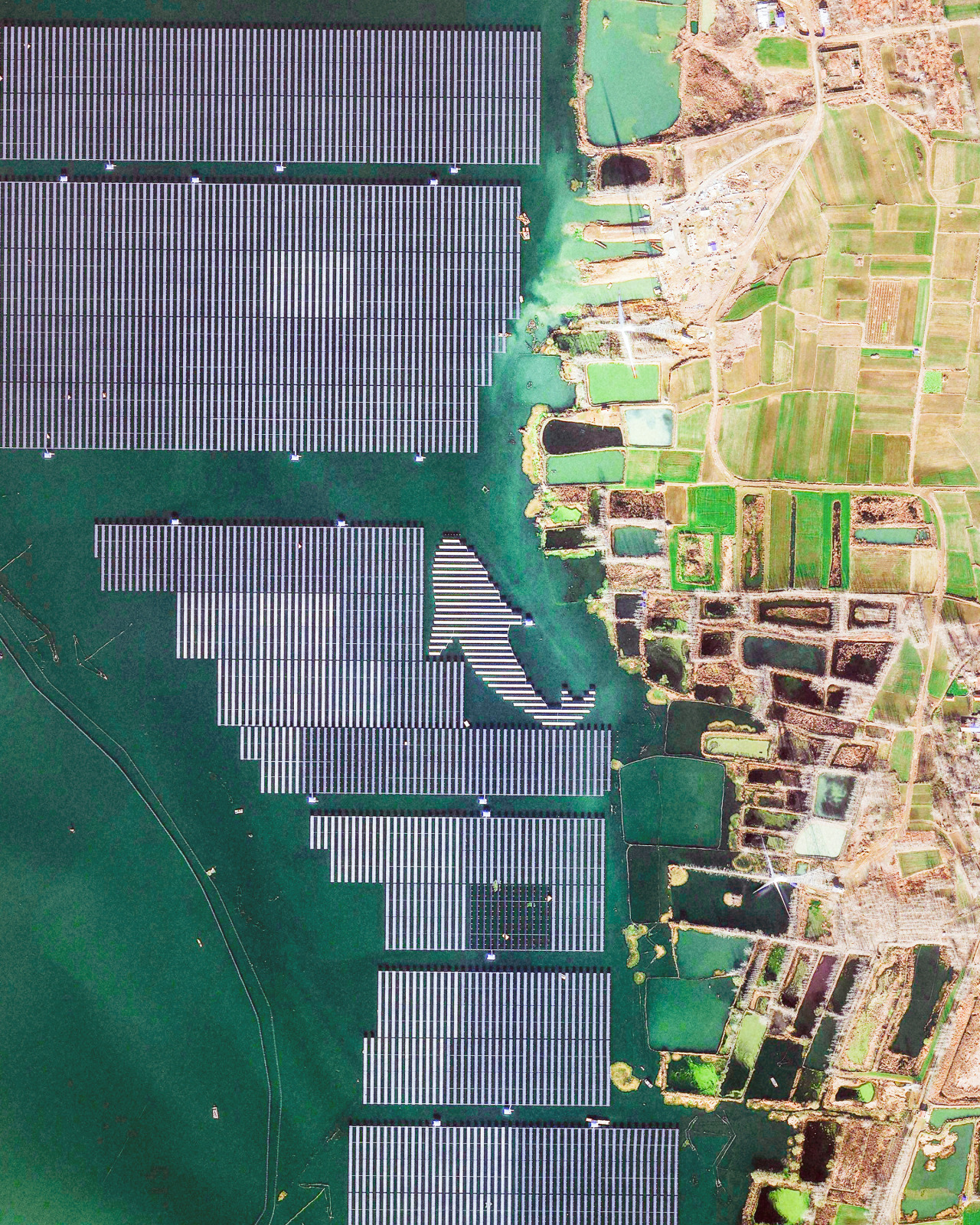 A solar panel “fish” is seen amid a large array on Tiangang Lake in Jiangsu Province, eastern China. This solar project, which covers nearly half of the lake’s perimeter, is a combination of a fishery and a photovoltaic power plant with a capacity of...