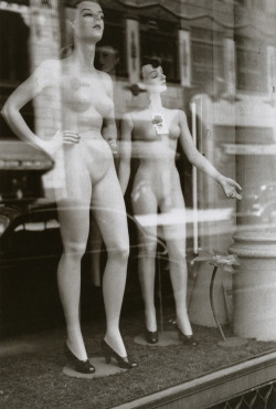 Two female mannequins stand undressed in