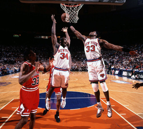 Patrick Ewing grabs a rebound over New York Knicks teammate Charles Oakley during Game 3 of the East