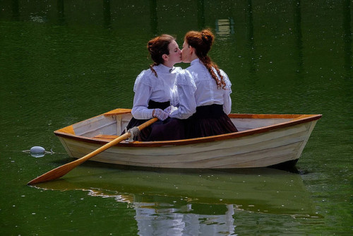 kristalknobb: performance art - two women, dressed in Edwardian clothes, quietly float on a pond, en