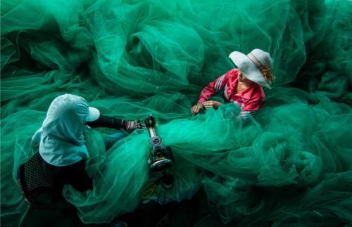 Women sewing a fishing netVinh Hy, VietnamPhoto by Quang Tran