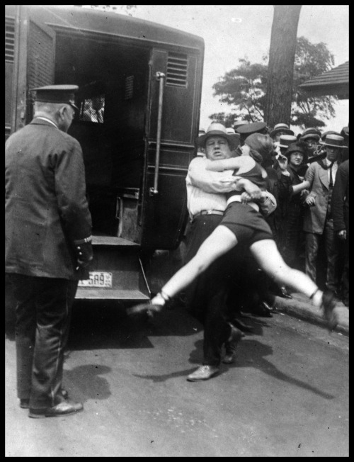 lostpolaroids:   Women in Chicago being arrested for wearing one piece bathing suits, without the required leg coverings; 1922.