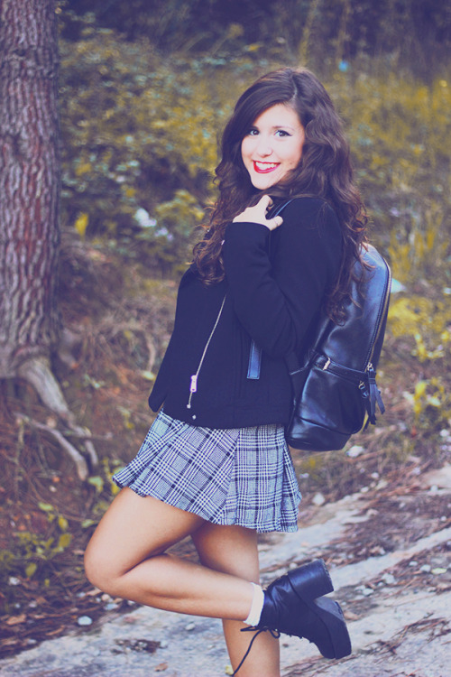 White ankle socks with black boots, pleated skirt and college bag