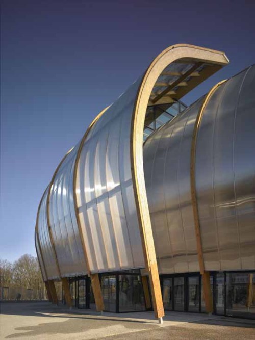 archatlas:  Limoges Concert Hall Bernard Tschumi Architects “The concept for the project began with a double envelope: an outer skin made of wood arcs and translucent rigid polycarbonate sheets and an inner acoustical envelope of locally grown