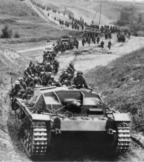 Short-barrelled StuG III Leading A Column Of German Soldiers Into Russia, 1941