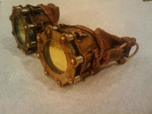 A set of seam punk goggles. Made from brass, stainless steel, and leather; these goggles use notch-filter glass to provide the user with a red-less view of the world. This was a fun build I did over my last summer in high school.