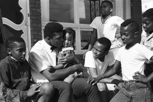 lostinurbanism:  Muhammad Ali with neighborhood kids outside of his mother’s home