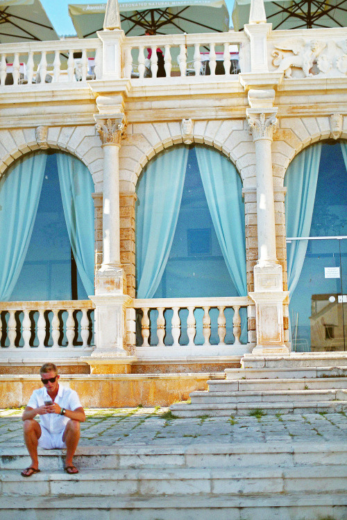 Guy in white, beautiful building. 