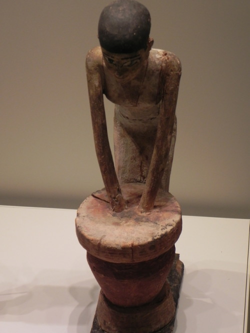 Ancient Egyptian wooden figurine of a worker brewing beer.  Now in the Israel Museum, Jerusalem.  Ph