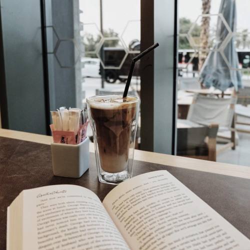 Reading at a cafe. ☕️   #readingspot #booksandcoffee #cafe #cafeandbooks #icedlatter #buzzfeedbooks 