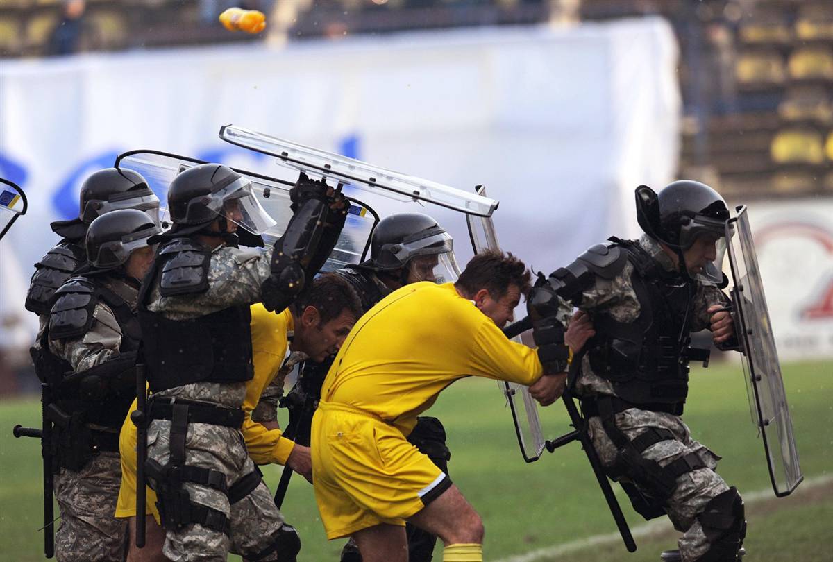 Macedonian special police forces try to protect the referees from the angry football fans after the Macedonian national league match between Teteks and Skendija (both from Tetovo) in Tetovo, Nov 2010.
EPA/Georgi Licovski
1200x810