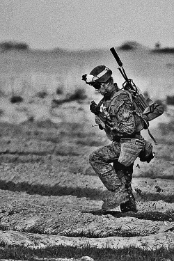 gunsandposes:  The slog of war: U.S. Marine Corps Lance Cpl. Caleb Hackbarth walks through the Afghan mud during a partnered patrol in Afghanistan’s Helmand province. November 27, 2012.