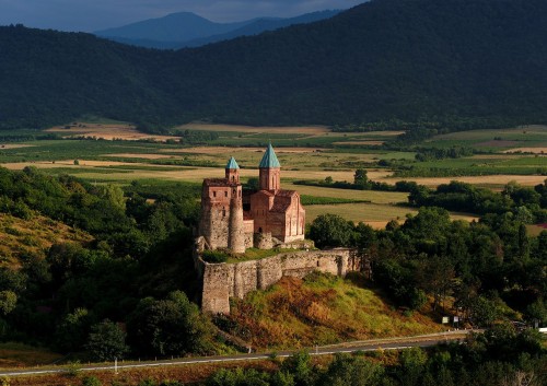 Gremi church and castle, in Kakheti, Georgia, with its backdrop of vineyards lit by the morning sun.